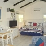 Cottages by the Ocean - King studio bed and dining table.