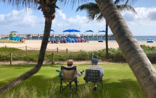 Photo of Two Travelers Near the Beach in the City of Pompano Beach.