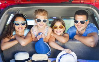 Photo of a Small Family in the Car. Safe Travel in the USA is Possible This Summer!