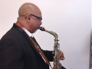 A saxophonist playing live music in Pompano Beach