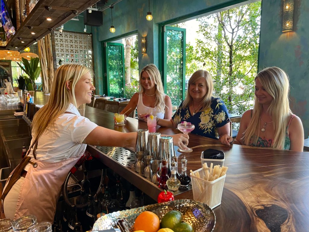 Women sitting at the bar at Baresco, a new restaurant in Pompano Beach