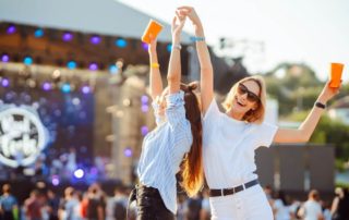 Two women dancing at a fall music festival in Pompano Beach